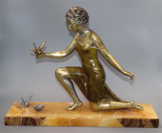 An Art Deco spelter figure of a girl with three birds, on marble base, signed U. Cipriani base length 50cm